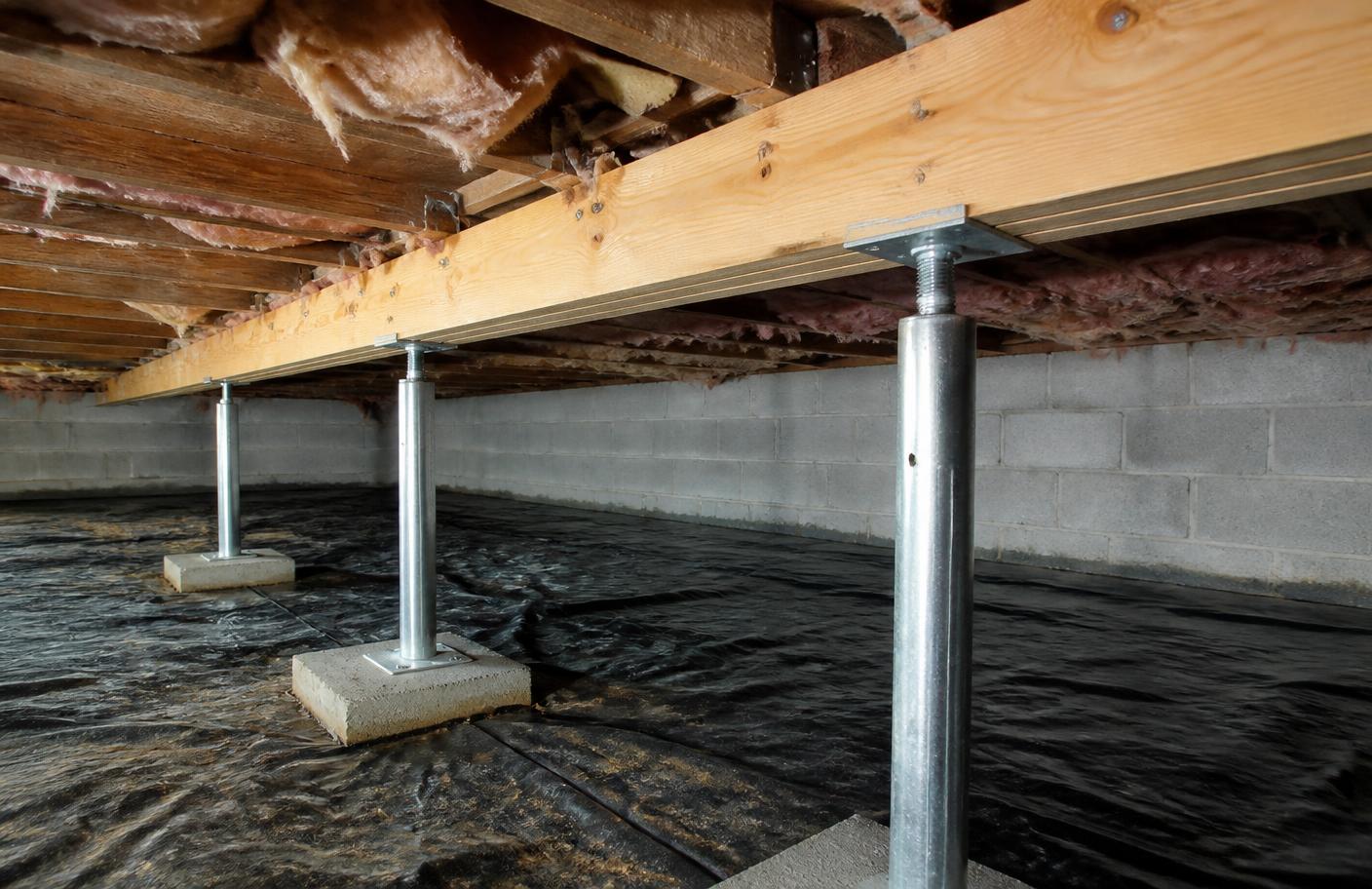 Steel support posts and a reinforced beam supporting floor joists in a crawl space